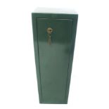 A contemporary green metal gun cabinet. Capable of holding four guns, with key, H87cm x W28cm x D22.