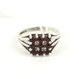 A silver and garnet square cluster ring.