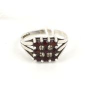 A silver and garnet square cluster ring.