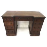 A mahogany veneered reverse break-front twin pedestal desk.