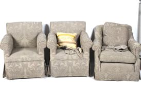 A collection of three, two plus one, grey upholstered armchairs.