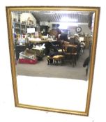 A large rectangular gilt framed bevelled edge wall mirror.