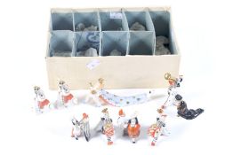 A set of nine 'Emperors New Clothes' porcelain figures. Featuring a variety of characters, Max. H6.