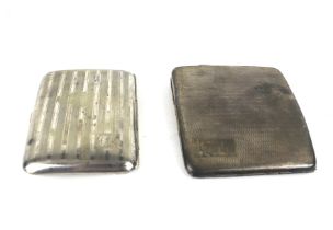 Two concave-rectangular cigarette cases.