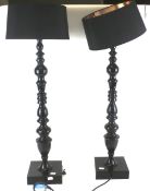 A pair of black metal table lamps.