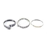 Three silver bangles. Including a snake example and another with a Celtic weave, 42.