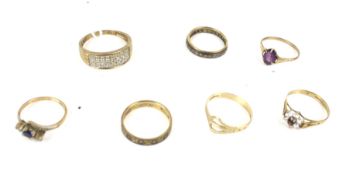 A group of seven 9ct gold and gem set dress rings.