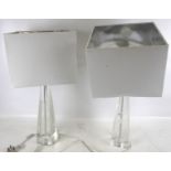 A pair of clear glass table lamp bases. With square shades.