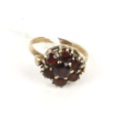 An early 20th century rose gold and garnet cluster ring.