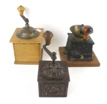 A collection of three assorted vintage hand coffee grinders. Max.