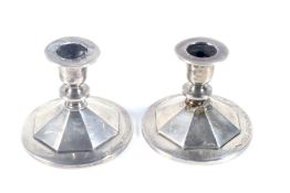 A pair of silver short round candlesticks.