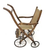 An Edwardian wood and canvas folding child's pushchair.