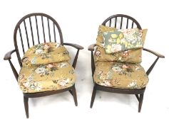 A pair of Ercol Quaker back carver chairs.