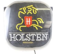 A fluorescent 'Holsten' advertising sign.
