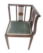An Edwardian mahogany corner chair.
