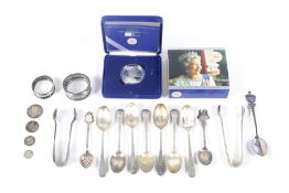 A collection of late Victorian and later silver small spoons and other items.