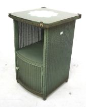 A Lloyd Loom 'Lusty' bedside cabinet. Coloured green with gilt details and a glass top, H64cm x W40.