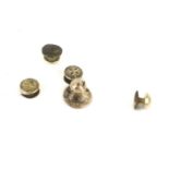 An assortment of stud earrings. Comprising two 18ct gold small studs, 2g; a 9ct gold stud, 0.