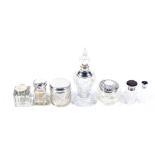 A collection of silver mounted clear cut glass scent bottles, a dressing table jars and an ink well.