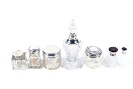 A collection of silver mounted clear cut glass scent bottles, a dressing table jars and an ink well.