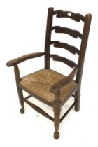 A 20th century child's ladderback carver chair.