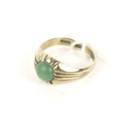 A far eastern small jadeite round cabochon single stone gypsy ring, stamped '14K', size M, 3.