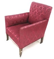 A red upholstered armchair on casters.