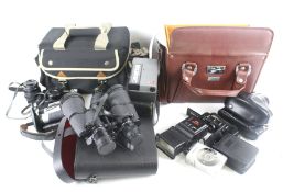 An assortment of vintage cameras and optical items.