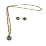 A 9ct gold and black South-Sea cultured-pearl pendant and chain, a pair of stud earrings en suite.