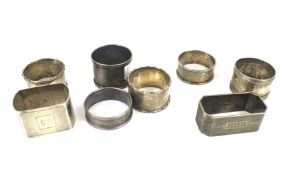 Eight silver napkin rings.