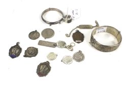 A silver broad hinged bangle and other items.