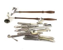 A silver candle snuffer and collection of small silver spoons and various silver-handled tea knives.