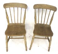 Two pine spindle back dining chairs. On turned supports united by stretchers.