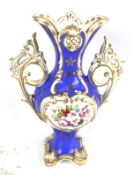 English hand painted ceramic twin handle vase. Blue ground, floral and gilt decoration.