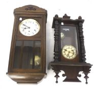 Two pendulum wall clocks.