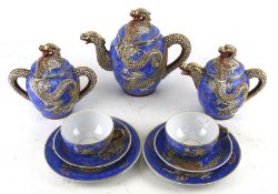 A Japanese lithophane geisha tea set. Including two 'dragon' pots, two cups and saucers, etc.