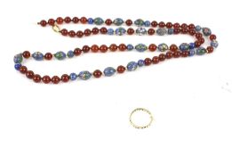 A vintage gold and paste eternity ring and a carnelian and coloured glass bead necklace.