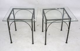 A pair of metal framed and glass top square coffee tables.