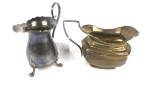 A silver baluster-shaped cream jug in George III style and an oblong milk jug.