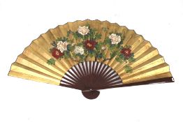 A large contemporary Chinese fan. With red lacquer struts and floral decoration on paper. 89cm long.