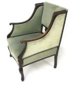 An Edwardian mahogany inlaid upholstered armchair. Serpentine front, on cabriole legs.