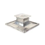 A silver square capstan-shaped inkwell.