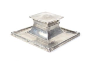 A silver square capstan-shaped inkwell.