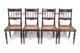 A set of four Regency mahogany and rosewood dining chairs.