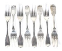 Eight various George III and later silver fiddle pattern dessert forks.