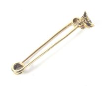 A Continental gold and rose diamond fox mask stock pin.