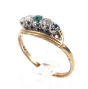 A mid-20th century gold, emerald and diamond five stone ring.