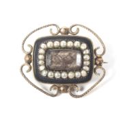 A Victorian gold, half-pearl and black onyx mourning brooch.