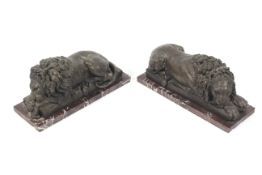 A pair of 20th century handed recumbent spelter lions.