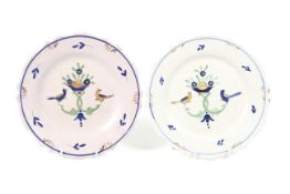 A pair of 18th/19th century polychrome majolica plates. Depicting birds and a flower in a dish, 24.